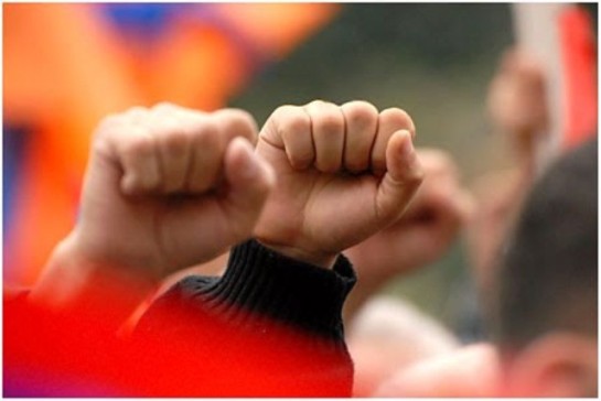 Photo of some fists held high in common protest